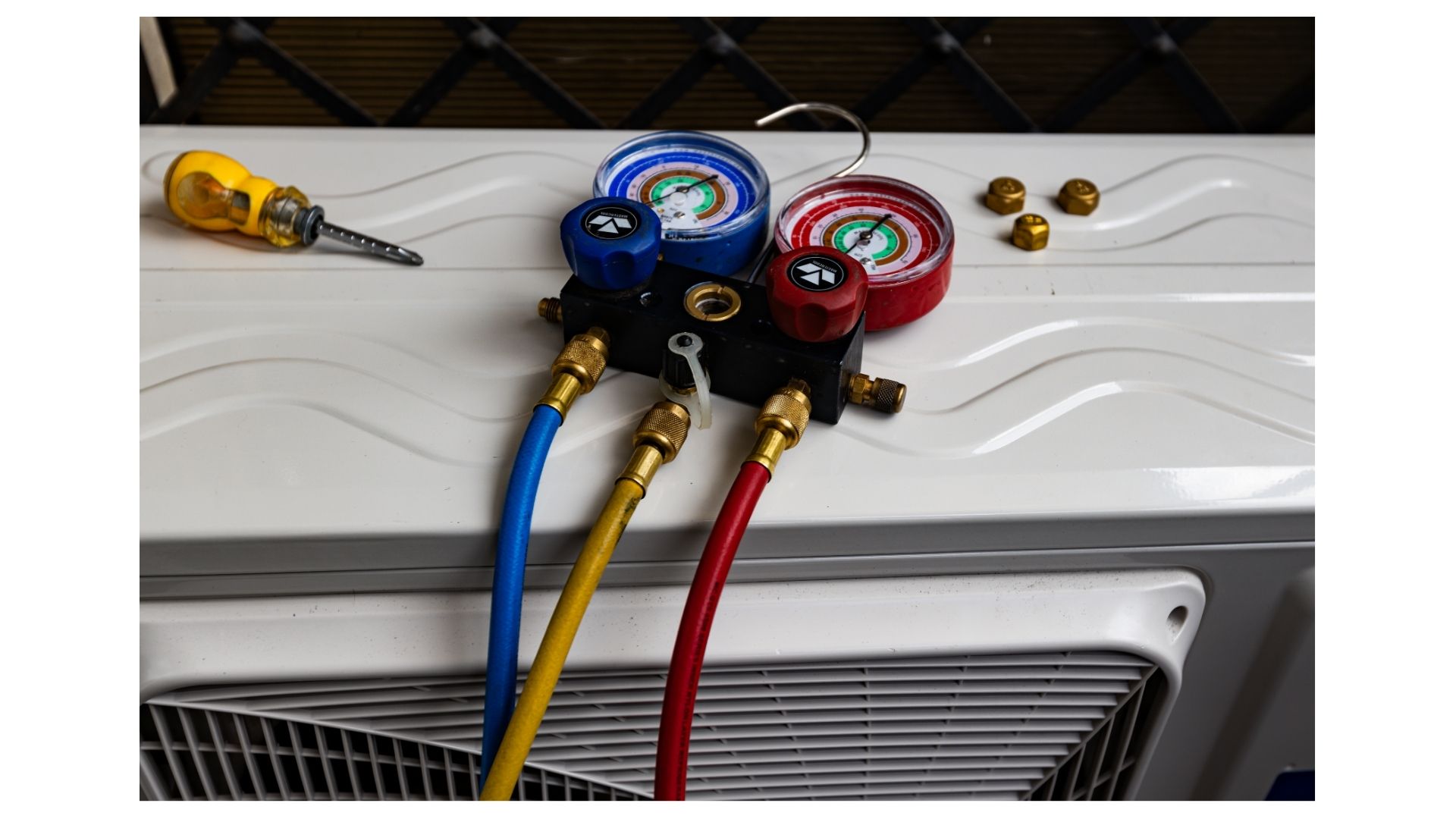 AC refrigerant Branson MO - Now! Heating & Cooling technician checking refrigerant gauges on AC unit