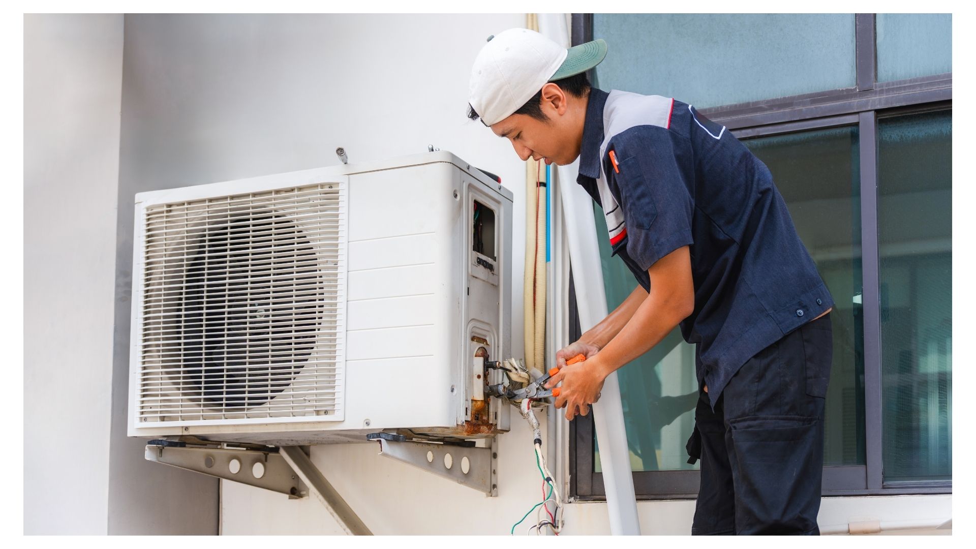 HVAC technician performing an AC tune-up on an outdoor air conditioning unit in Branson, MO