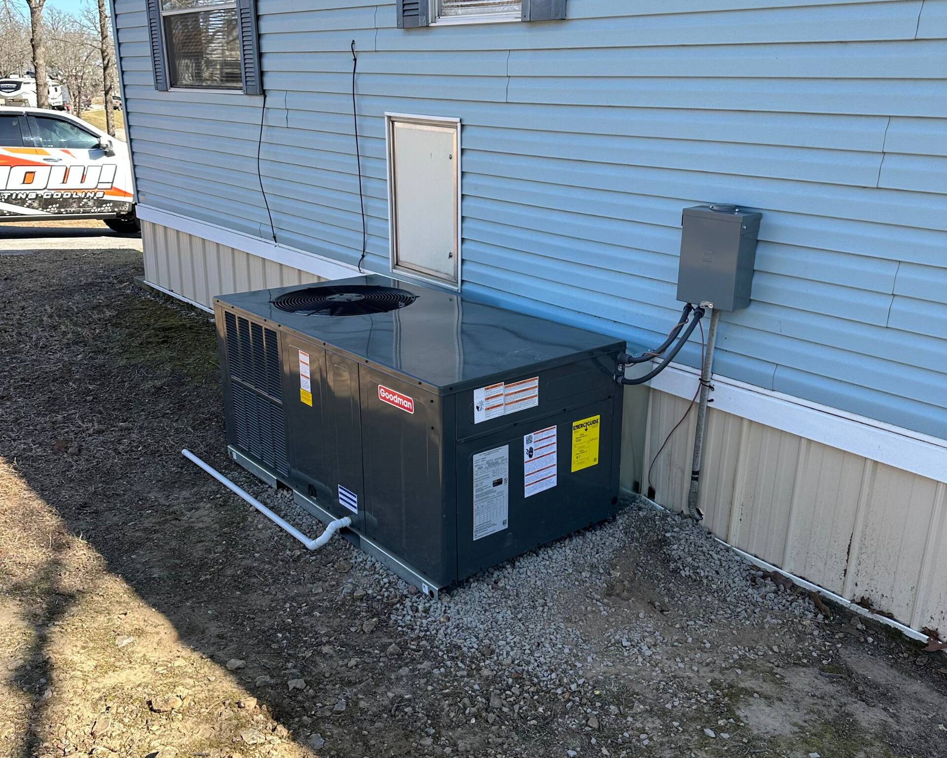 commercial HVAC Branson MO - Now! Heating & Cooling technician servicing rooftop commercial AC unit