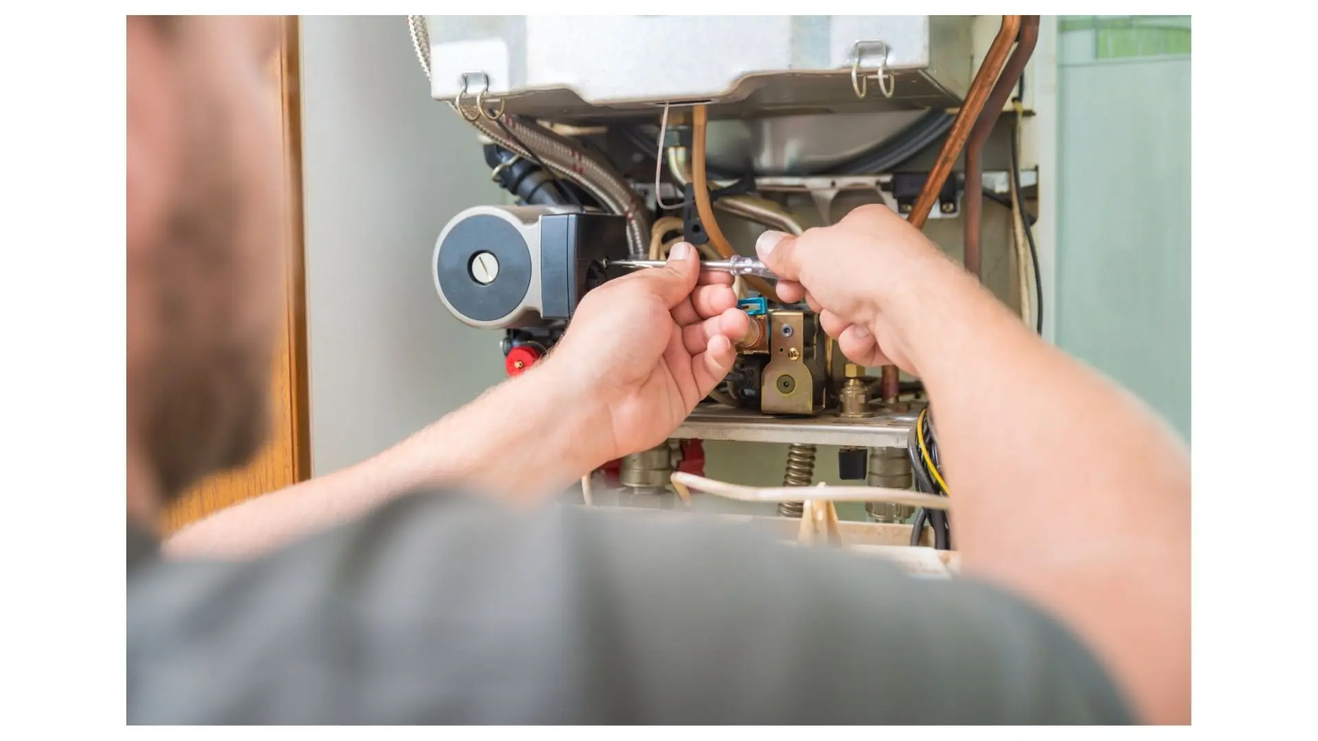 Technician's hands repairing furnace components