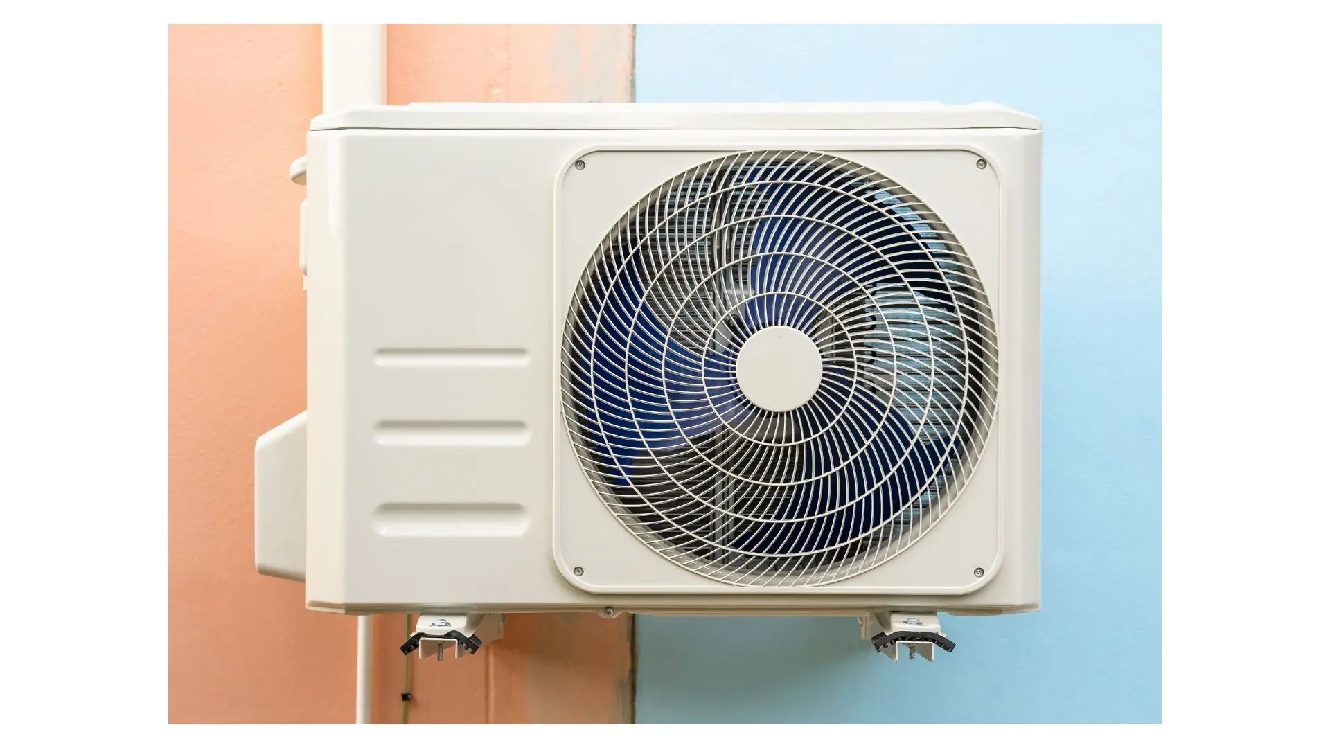 Outdoor mini-split condenser mounted on an exterior wall